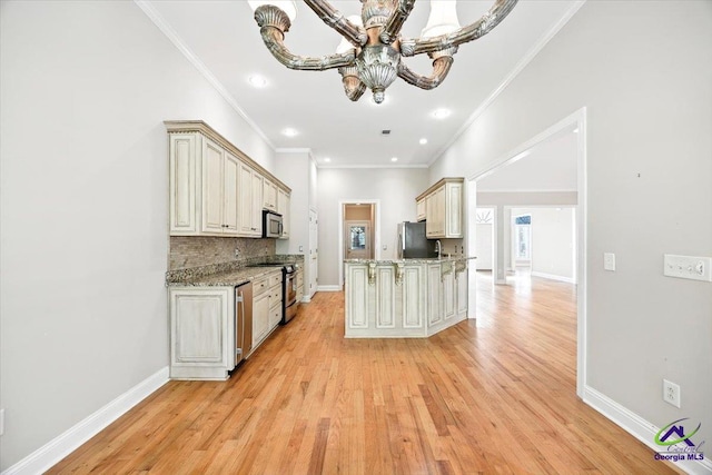 208 W Troon, Macon, GA 31210 - kitchen with appliances with stainless steel finishes, light wood finished floors, crown molding, a chandelier, and decorative backsplash