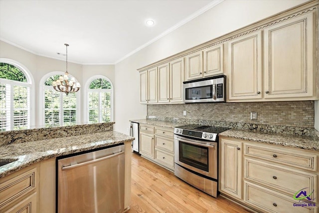 208 W Troon, Macon, GA 31210 - kitchen with appliances with stainless steel finishes, cream cabinetry, light wood-type flooring, decorative backsplash, and crown molding