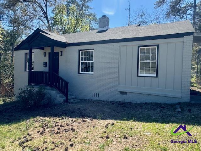 1930 Northbrook Ave, Macon, GA 31204 - ranch-style house with a chimney, brick siding, crawl space, a front lawn, and board and batten siding