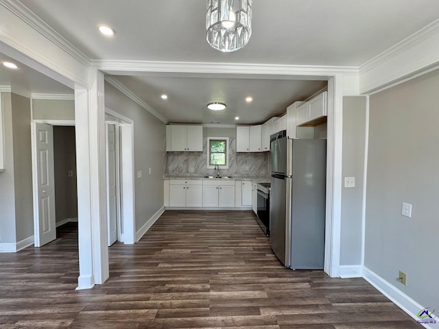 1930 Northbrook Ave, Macon, GA 31204 - kitchen featuring appliances with stainless steel finishes, light countertops, dark wood-style flooring, decorative backsplash, and a chandelier