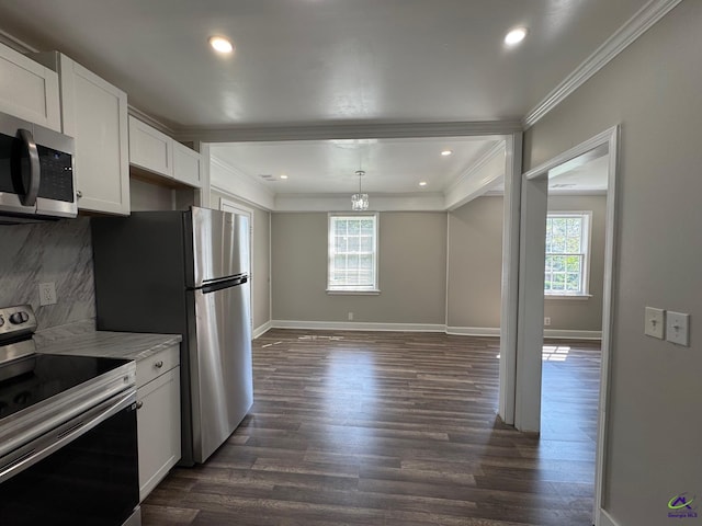 1930 Northbrook Ave, Macon, GA 31204 - kitchen featuring stainless steel appliances, crown molding, dark wood-style floors, white cabinetry, and decorative backsplash