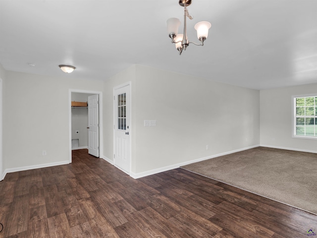 539 Levi Barnes Rd, Jackson, GA 30233 - unfurnished room with a chandelier and dark wood-style flooring
