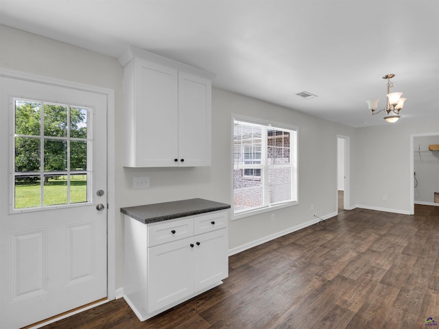 539 Levi Barnes Rd, Jackson, GA 30233 - kitchen featuring dark countertops, a chandelier, dark wood-style floors, white cabinets, and decorative light fixtures