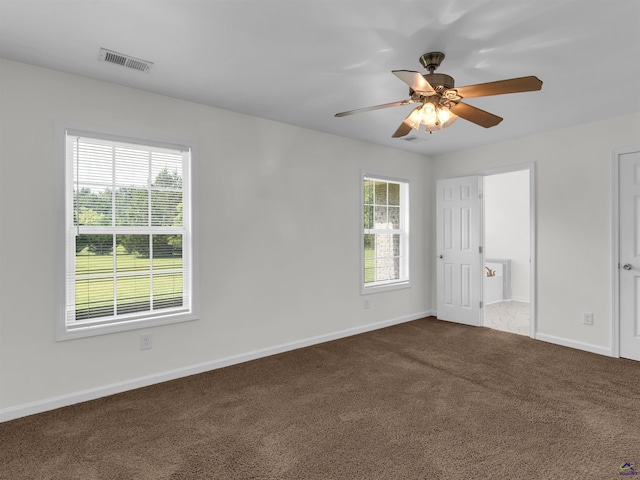 539 Levi Barnes Rd, Jackson, GA 30233 - unfurnished bedroom with dark carpet, ensuite bathroom, and ceiling fan