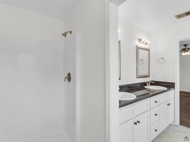 539 Levi Barnes Rd, Jackson, GA 30233 - bathroom featuring double vanity, a shower, marble look tiles, and a ceiling fan