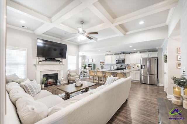 306 Gibson Cir, Kathleen, GA 31047 - living area featuring ceiling fan, dark wood finished floors, coffered ceiling, beam ceiling, and a fireplace