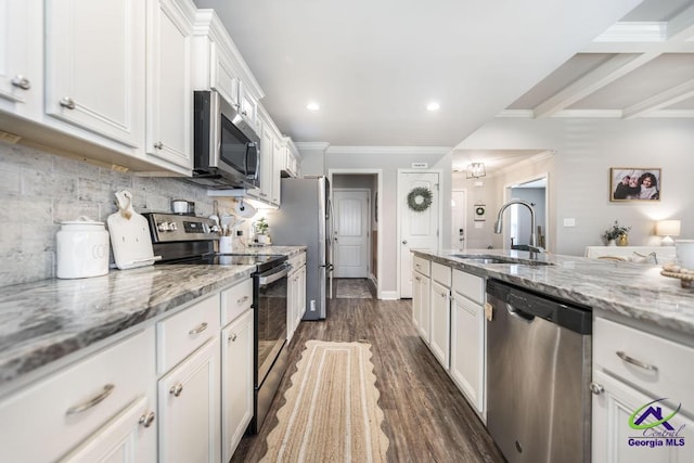 306 Gibson Cir, Kathleen, GA 31047 - kitchen with appliances with stainless steel finishes, white cabinetry, crown molding, decorative backsplash, and dark wood-type flooring