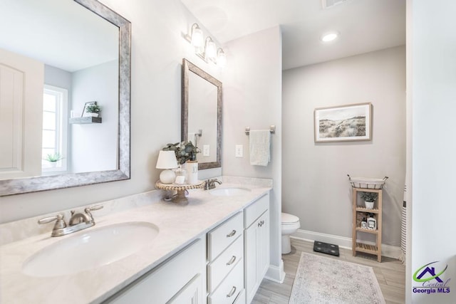 306 Gibson Cir, Kathleen, GA 31047 - full bathroom with double vanity and wood finished floors