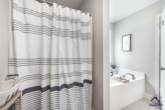 306 Gibson Cir, Kathleen, GA 31047 - bathroom featuring a bath and curtained shower