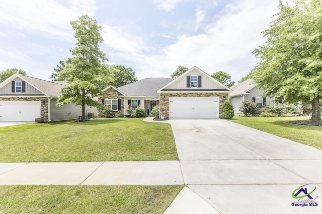 306 Gibson Cir, Kathleen, GA 31047 - craftsman-style house featuring stone siding, board and batten siding, driveway, and a front yard