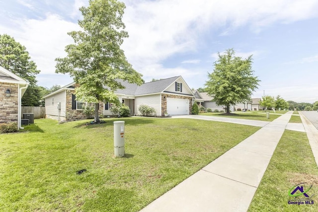 306 Gibson Cir, Kathleen, GA 31047 - view of front of home featuring driveway, stone siding, and an attached garage