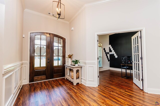 240 Woodlands Blvd, Kathleen, GA 31047 - entryway with french doors, wood finished floors, arched walkways, ornamental molding, and wainscoting