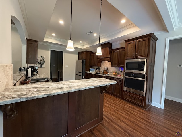240 Woodlands Blvd, Kathleen, GA 31047 - kitchen featuring stainless steel appliances, a raised ceiling, a peninsula, dark wood-style floors, and backsplash