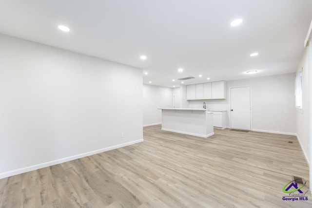 804 Arrowhead Trl, Warner Robins, GA 31088 - unfurnished living room featuring light wood finished floors and recessed lighting