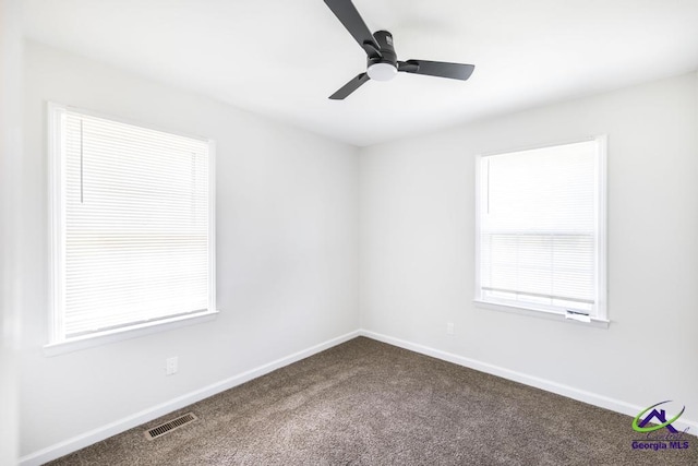 804 Arrowhead Trl, Warner Robins, GA 31088 - unfurnished room with dark colored carpet, healthy amount of natural light, and ceiling fan