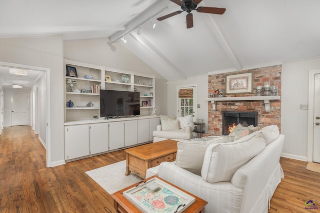 4871 Oxford Rd, Macon, GA 31210 - living area with wood finished floors, ceiling fan, a brick fireplace, and rail lighting