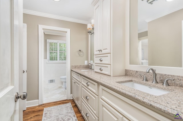 4871 Oxford Rd, Macon, GA 31210 - full bathroom featuring double vanity, wood finished floors, crown molding, and tile walls