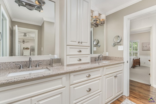 4871 Oxford Rd, Macon, GA 31210 - bathroom with double vanity, ornamental molding, wood finished floors, wainscoting, and ceiling fan
