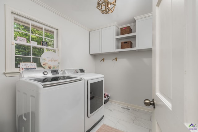 4871 Oxford Rd, Macon, GA 31210 - laundry area with separate washer and dryer, cabinet space, light marble finish floors, a chandelier, and ornamental molding