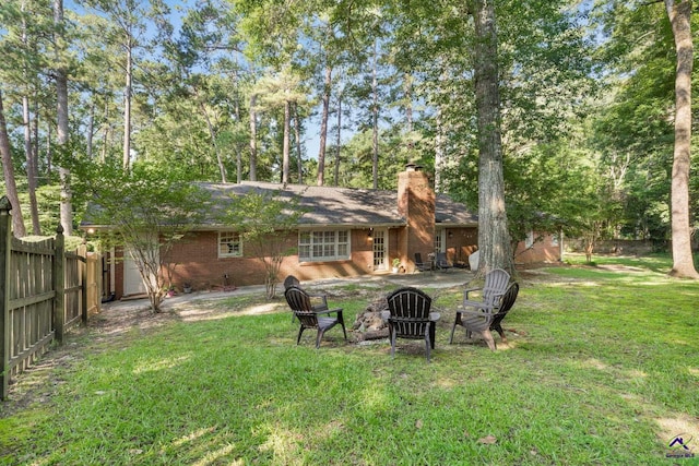 4871 Oxford Rd, Macon, GA 31210 - back of property with a chimney, brick siding, and an outdoor fire pit