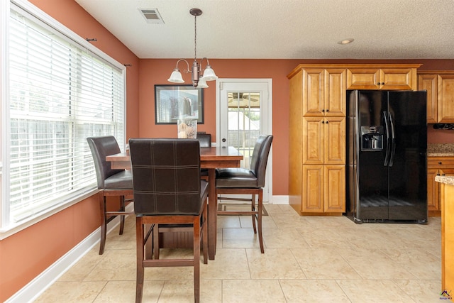 413 Madison Place Parkway, Byron, GA 31008 - dining space with a chandelier, a textured ceiling, and light tile patterned flooring