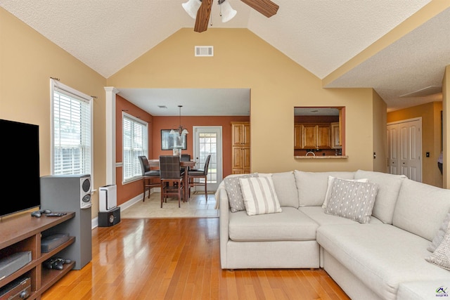 413 Madison Place Parkway, Byron, GA 31008 - living area with vaulted ceiling, ceiling fan, light wood-type flooring, and a textured ceiling