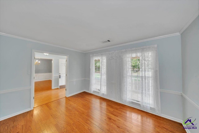 105 International Blvd, Warner Robins, GA 31088 - spare room featuring hardwood / wood-style flooring, crown molding, and a chandelier