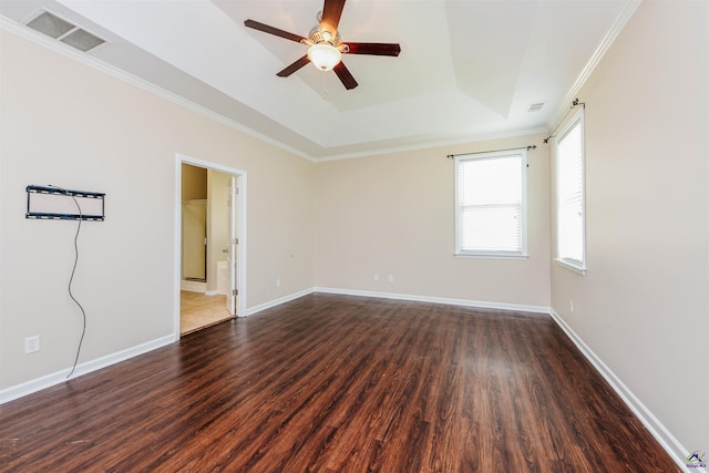 202 Stafford Beach Dr, Byron, GA 31008 - empty room featuring ceiling fan, a tray ceiling, dark wood-style floors, and crown molding