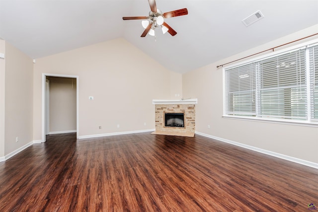 202 Stafford Beach Dr, Byron, GA 31008 - unfurnished living room featuring ceiling fan, vaulted ceiling, a fireplace with flush hearth, and dark wood finished floors