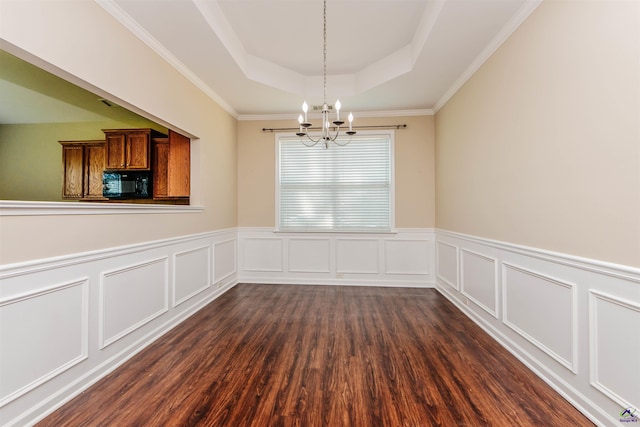 202 Stafford Beach Dr, Byron, GA 31008 - unfurnished dining area featuring a tray ceiling, a chandelier, dark wood-style floors, wainscoting, and a decorative wall