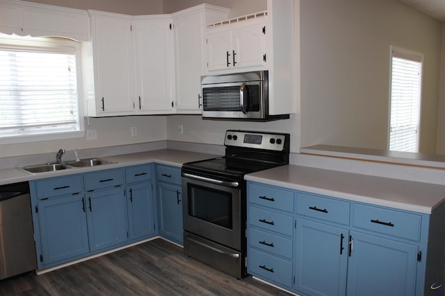 125 Buckskin Trl, Byron, GA 31008 - kitchen with blue cabinetry, stainless steel appliances, and dark wood-style flooring