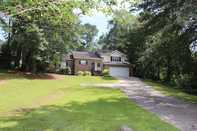 125 Buckskin Trl, Byron, GA 31008 - tri-level home featuring driveway, an attached garage, brick siding, and a front lawn