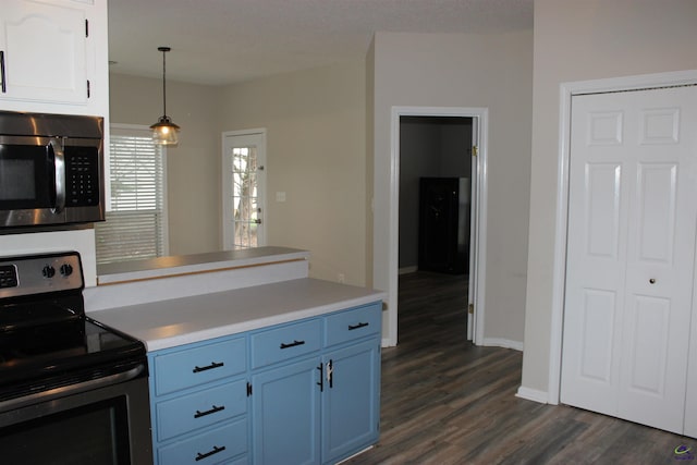 125 Buckskin Trl, Byron, GA 31008 - kitchen featuring appliances with stainless steel finishes, blue cabinetry, dark wood-style floors, light countertops, and hanging light fixtures