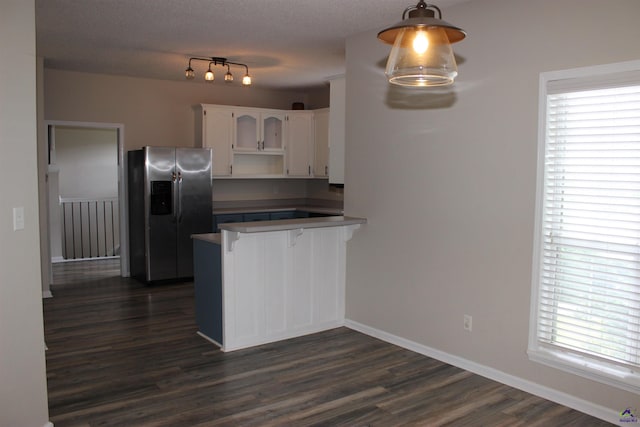 125 Buckskin Trl, Byron, GA 31008 - kitchen featuring stainless steel fridge with ice dispenser, a peninsula, white cabinets, dark wood-type flooring, and plenty of natural light