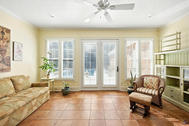 228 Lagrange Ct, Macon, GA 31210 - living room with tile patterned flooring, a ceiling fan, crown molding, and a textured ceiling