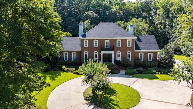 228 Lagrange Ct, Macon, GA 31210 - view of front facade with a chimney, a front lawn, brick siding, and curved driveway