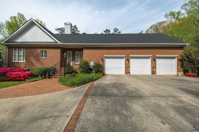 228 Lagrange Ct, Macon, GA 31210 - ranch-style house with concrete driveway, a chimney, an attached garage, and brick siding