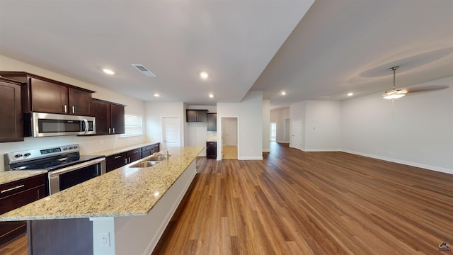 452 Southern Oaks Dr, Macon, GA 31216 - kitchen featuring appliances with stainless steel finishes, wood finished floors, dark brown cabinetry, a kitchen island with sink, and recessed lighting
