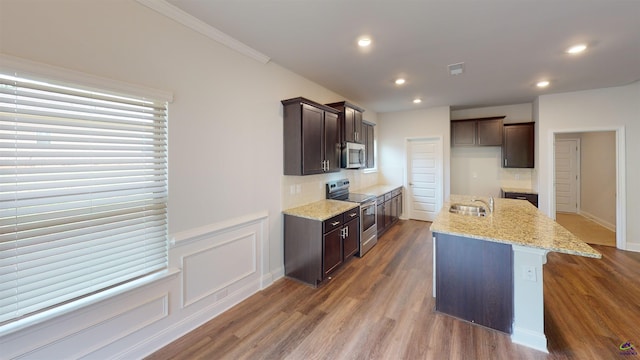 452 Southern Oaks Dr, Macon, GA 31216 - kitchen featuring stainless steel appliances, dark brown cabinetry, wood finished floors, recessed lighting, and crown molding