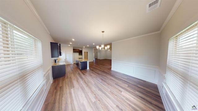 452 Southern Oaks Dr, Macon, GA 31216 - kitchen with a chandelier, open floor plan, light countertops, ornamental molding, and wood finished floors