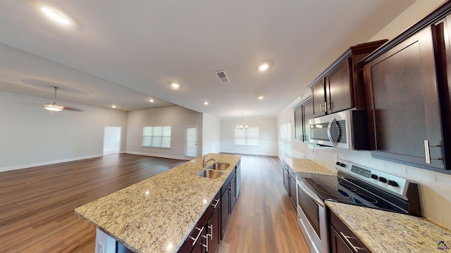 452 Southern Oaks Dr, Macon, GA 31216 - kitchen with stainless steel appliances, dark wood-style floors, an island with sink, and recessed lighting