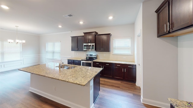 452 Southern Oaks Dr, Macon, GA 31216 - kitchen with stainless steel appliances, dark wood-style flooring, dark brown cabinetry, a chandelier, and an island with sink