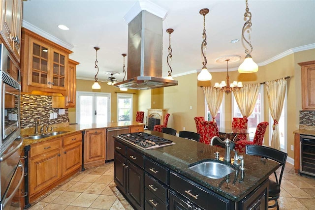 kitchen featuring backsplash, sink, light tile floors, and island range hood