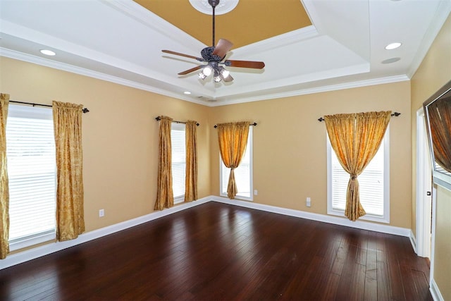 spare room with ceiling fan, crown molding, dark hardwood / wood-style floors, and a raised ceiling