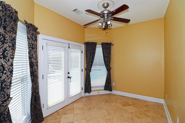 spare room featuring ceiling fan and light tile floors