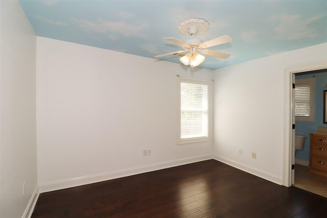 unfurnished room with ceiling fan and dark hardwood / wood-style flooring