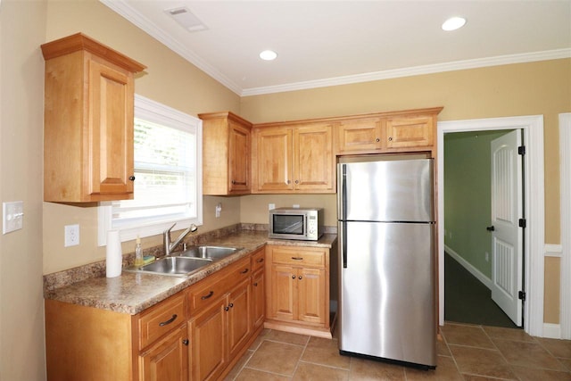 kitchen with crown molding, appliances with stainless steel finishes, light tile floors, and sink