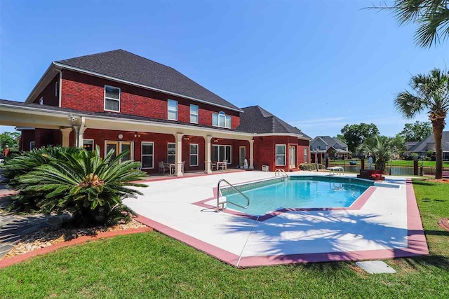 view of pool with a yard and a patio area