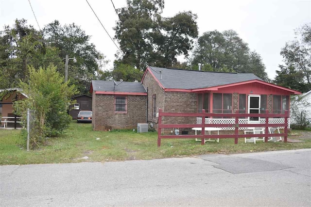 view of front of home featuring central air condition unit and a front lawn