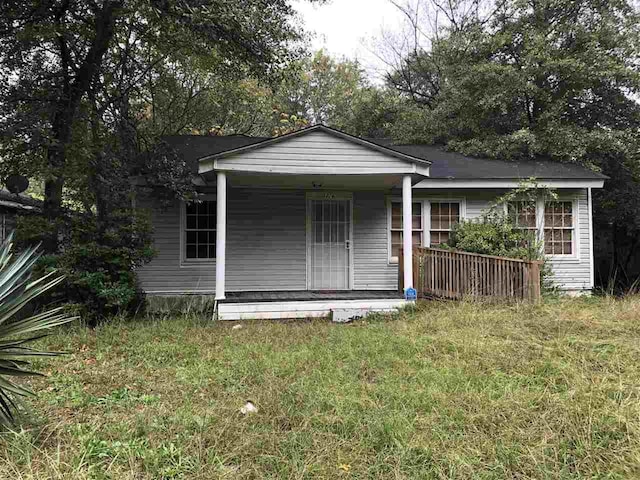 view of outdoor structure with a porch and a lawn